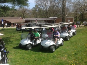 Pat, Dan, Nicole and Jon lead a caravan of golf carts at C-W outing.